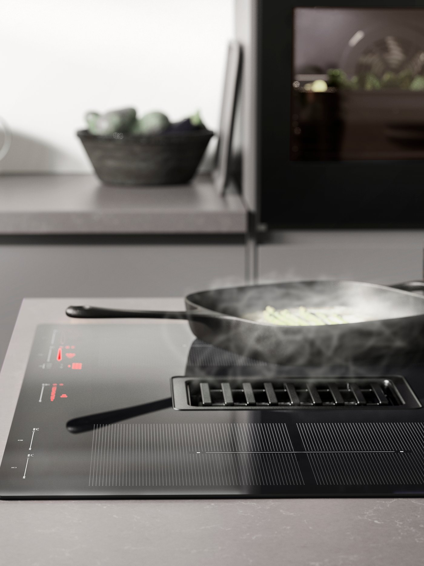 A cast iron VARDAGEN grill pan on an induction hob with integrated fan, in a modern grey kitchen