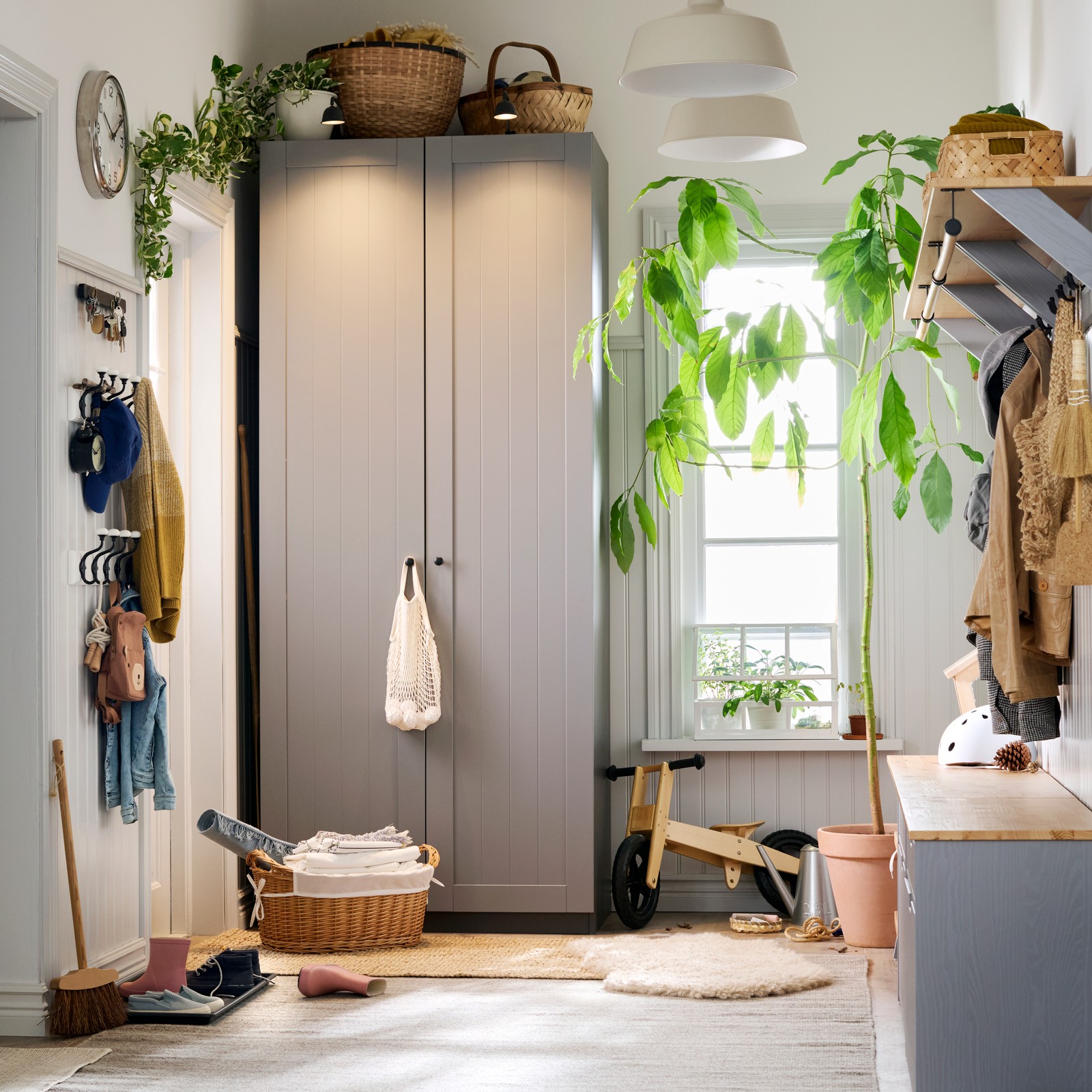 A family hallway with a PAX GULLABERG wardrobe and a window in the back. Things everywhere, but still in neat order.