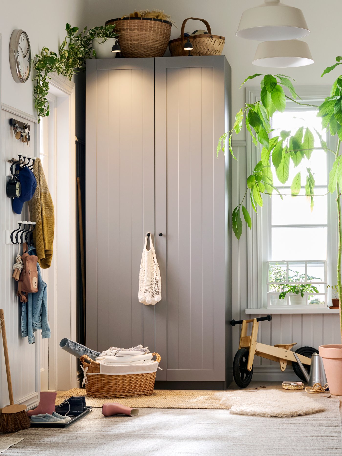 A family hallway with a PAX GULLABERG wardrobe and a window in the back. Things everywhere, but still in neat order.