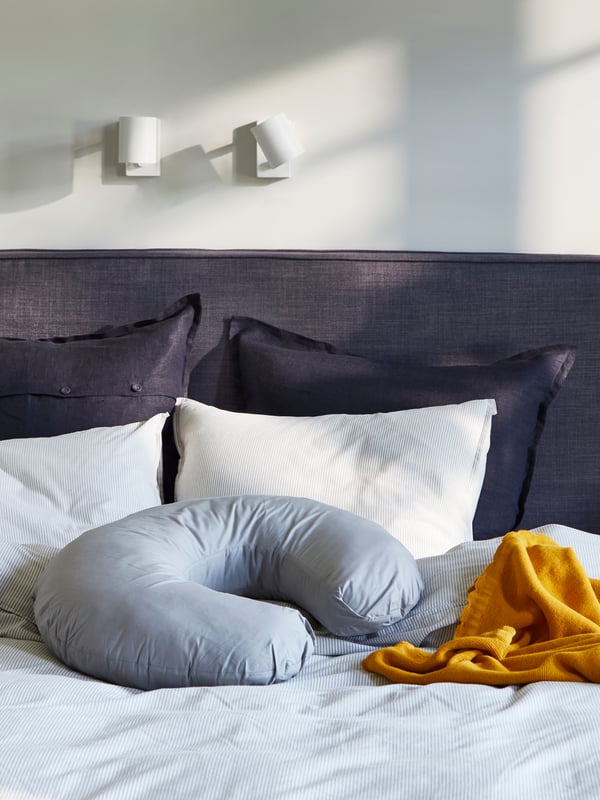 A grey LEN nursing pillow in the bedroom