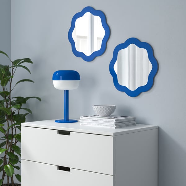 A blue PRUNKHALLON mirror