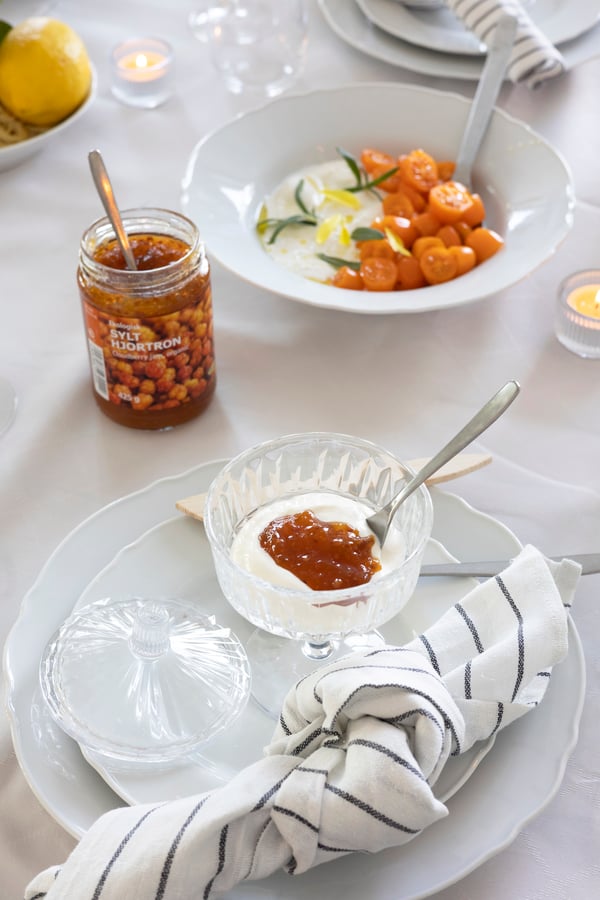 A vanilla dessert with jam topping served in a jar