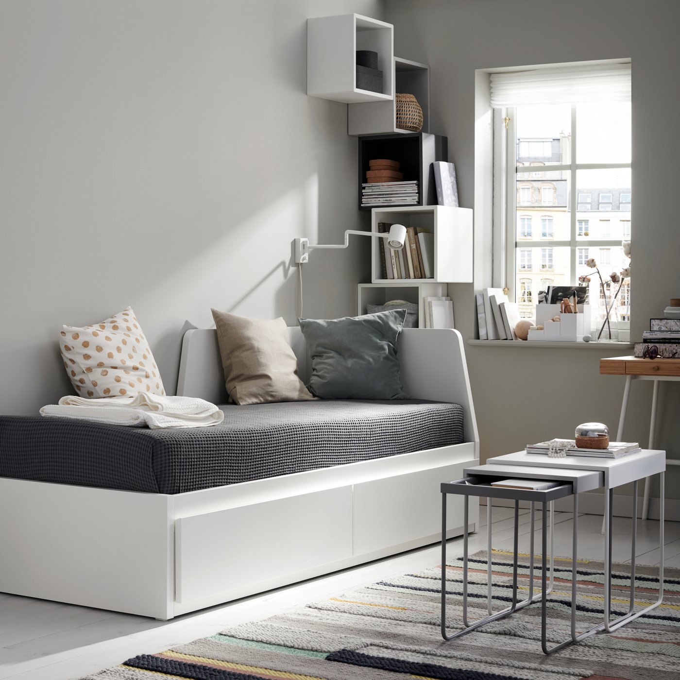 A white FLEKKE day-bed frame with 2 drawers