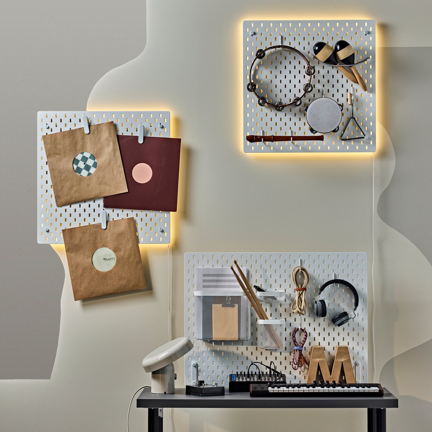 Three white SKÅDIS pegboards with music stuff hanging from the wall.