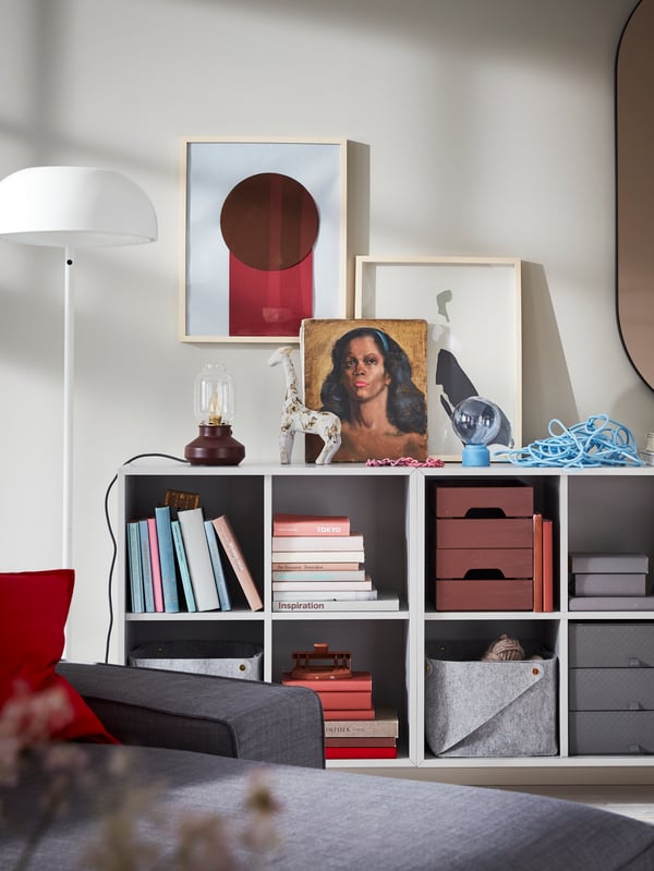 Wall-mounted EKET combination units in light gray offer open storage for books, baskets, boxes and more.
