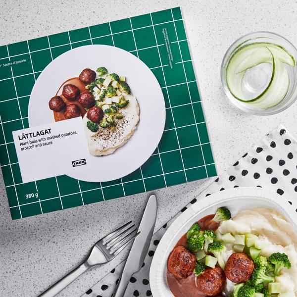 A lunch spread showcasing a selection of IKEA's iconic meatball plates, complete with mashed potatoes, peas, creamy gravy sauce, and lingonberry jam.
