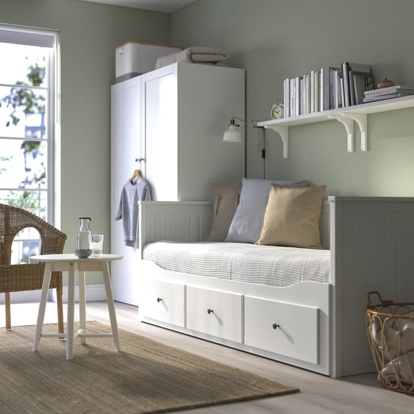 A HEMNES daybed with one of the drawers opened. 