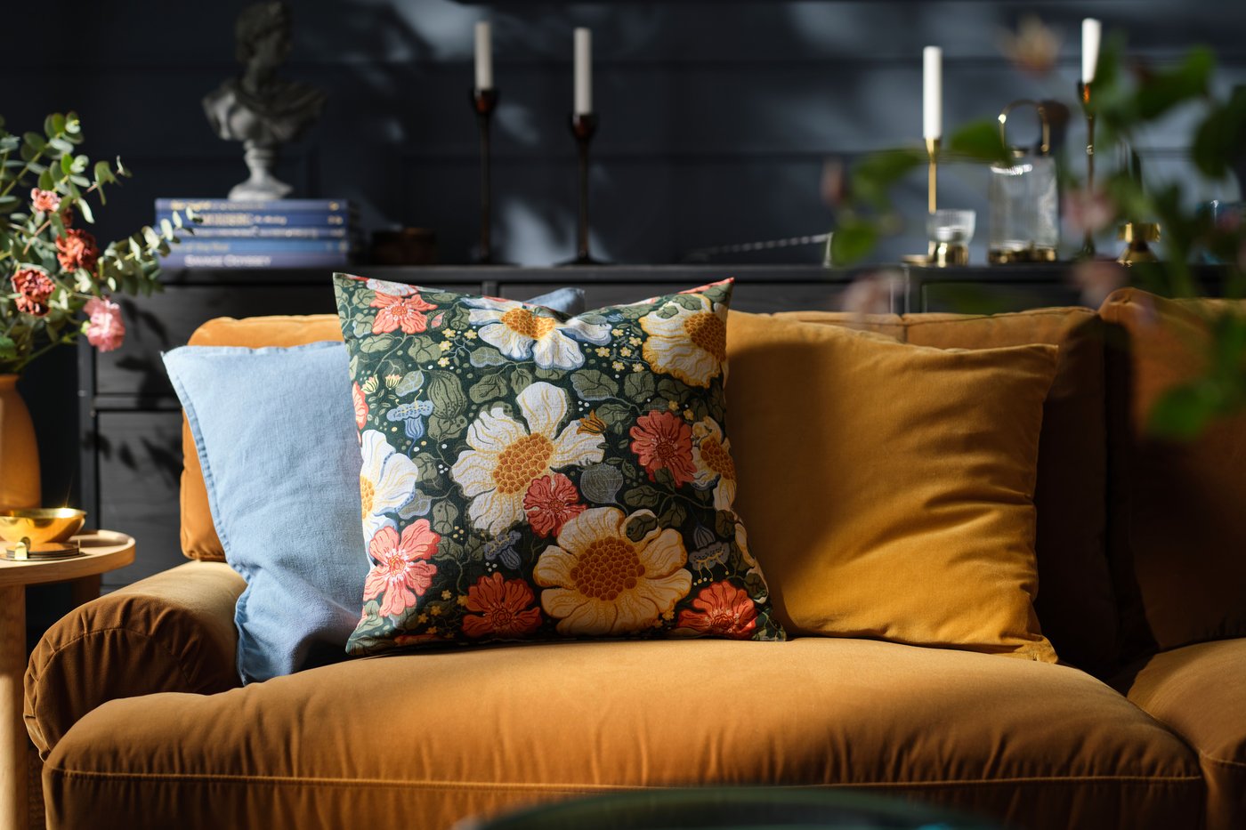 A green multicolour/floral pattern ARENBOK cushion cover in the living room
