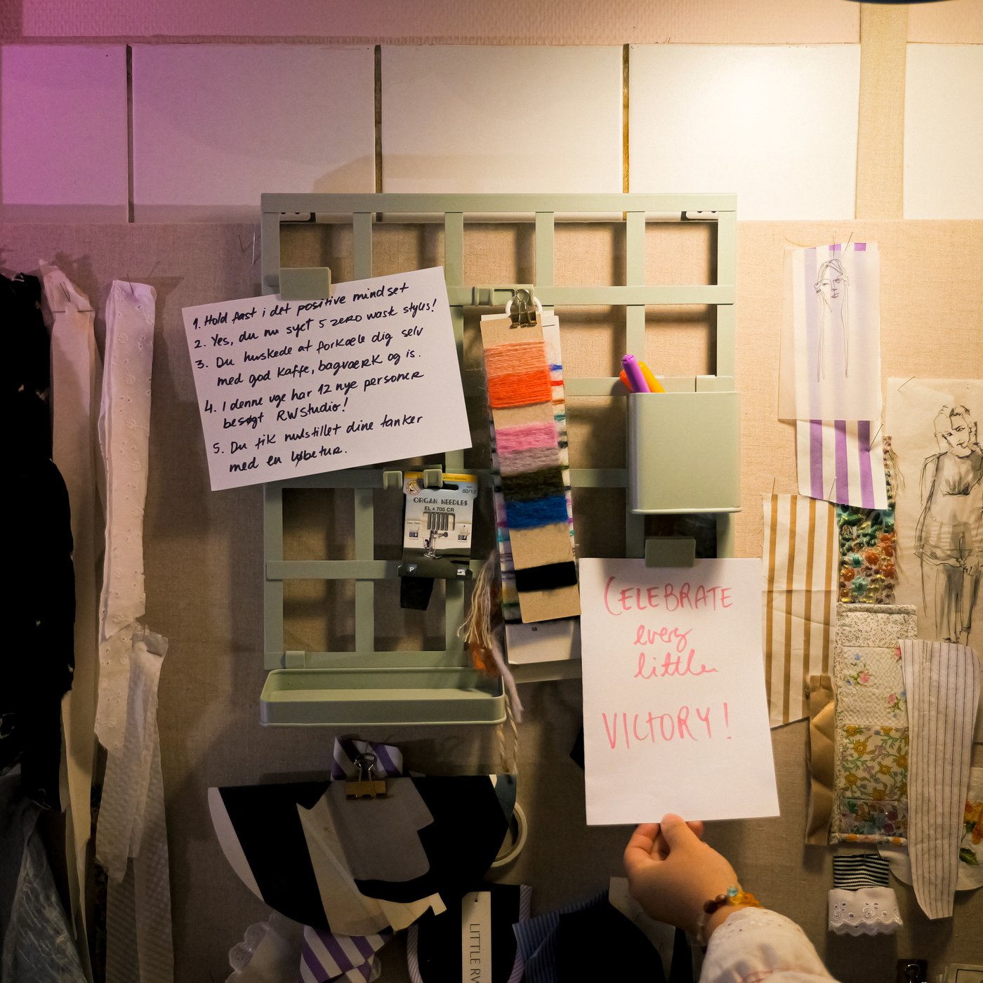 A note board with a big note that says: Celebrate every little victory.