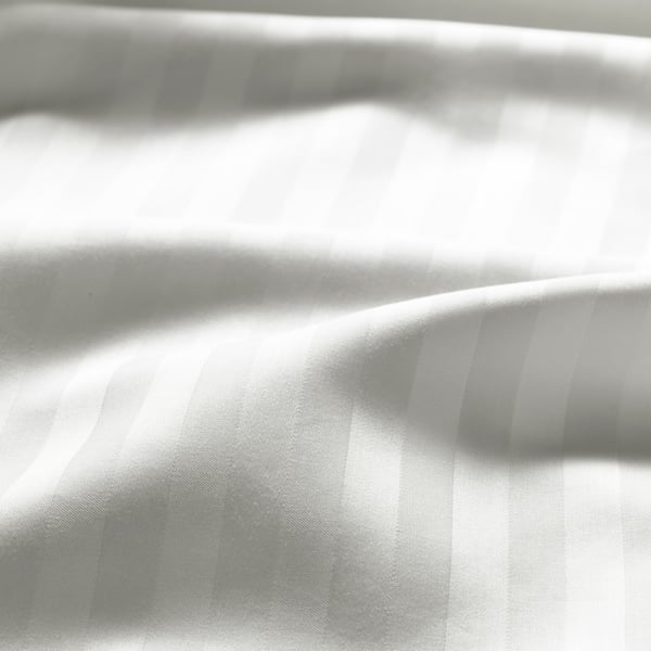 A close-up on white NATTJASMIN bed linen with a ripple in it to show the finish of the material.