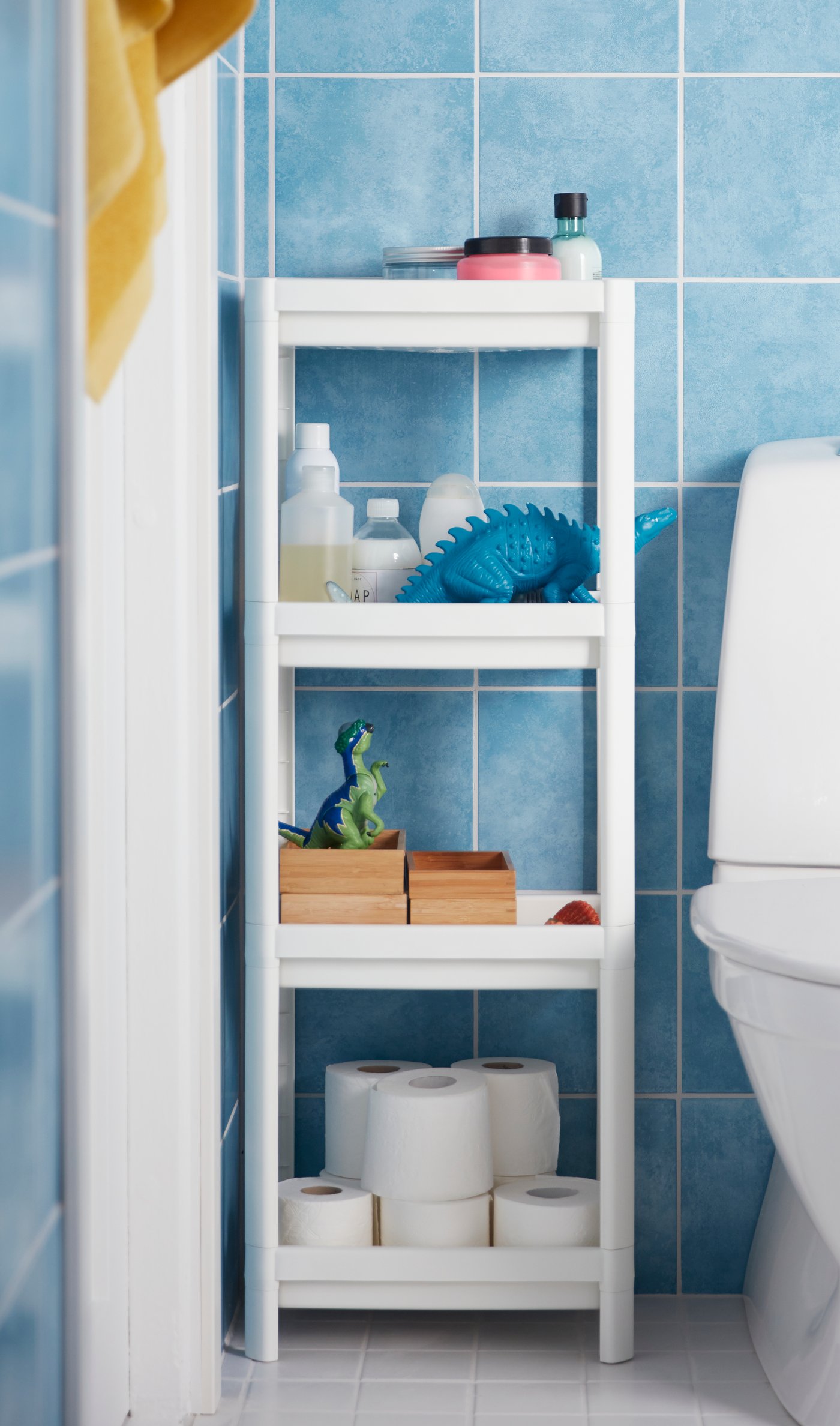 A white VESKEN shelf unit in the bathroom
