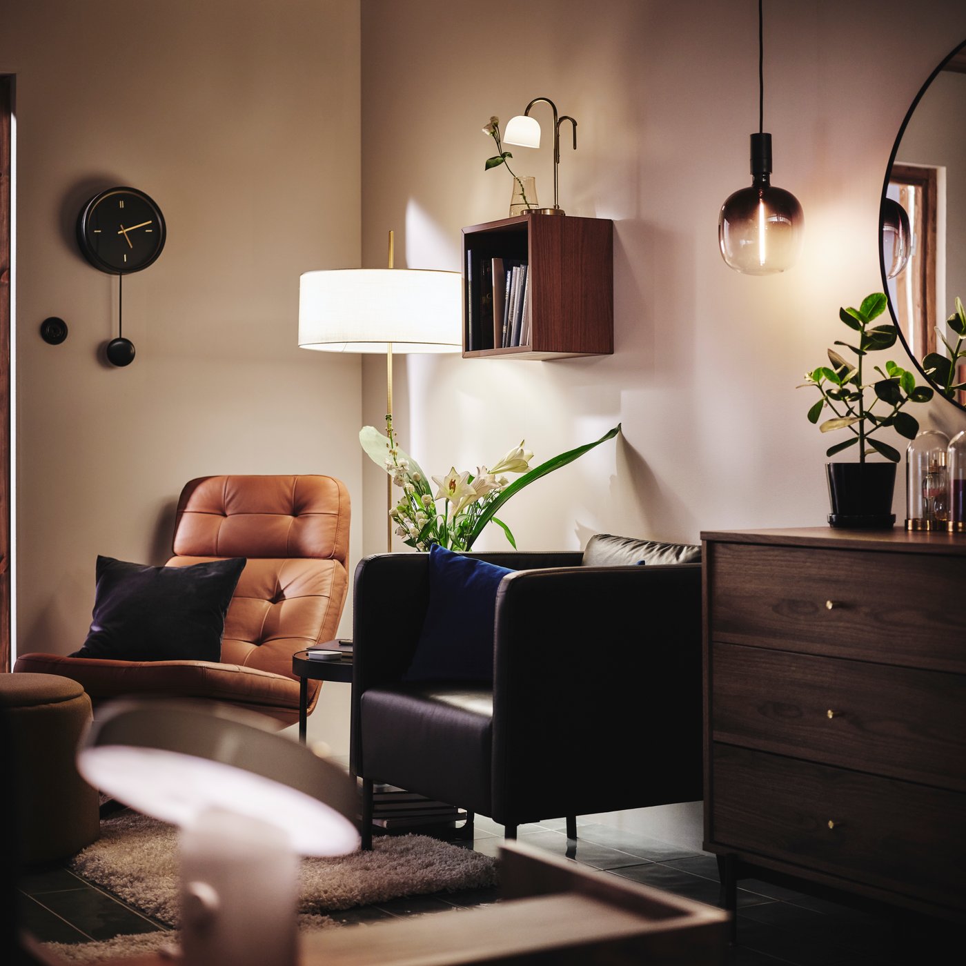 Relaxing corner in a bedroom, with two armchairs and different light sources such as STOCKHOLM 2025 floor lamp.