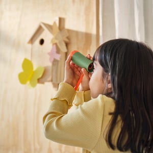 A green/orange MAJBAGGE monocular