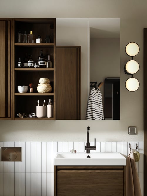 Bathroom featuring a grey LETTAN mirror cabinet with doors placed above a beige ÄNGSJÖN wash stand with drawers.