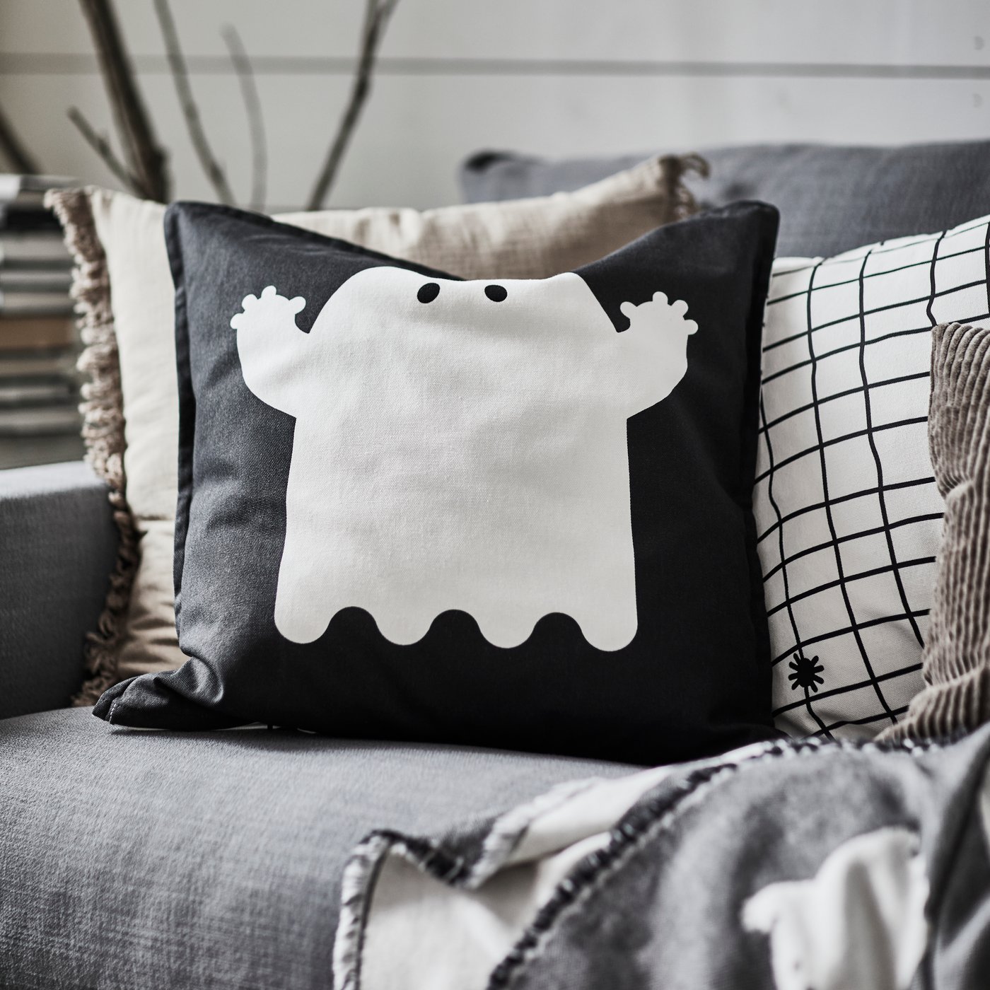 A light grey-brown VALLKRASSING cushion cover