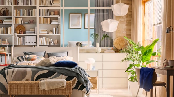Two white BÄCKNATE pendant lampshades hang above white MALM chests of 4 drawers near a bedroom window.