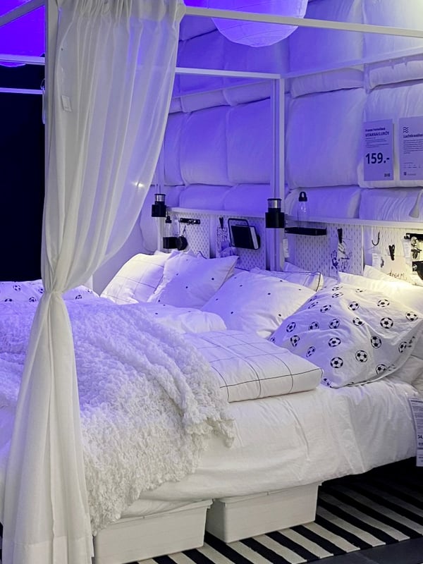 Two white two-person beds next to eacht other so they could fit the whole family