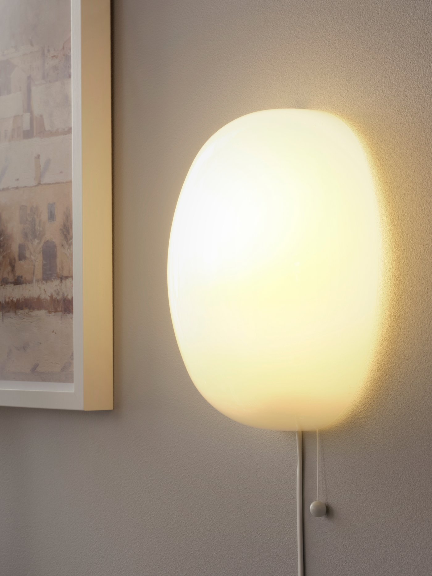 A white glass KALLBLIXT wall lamp