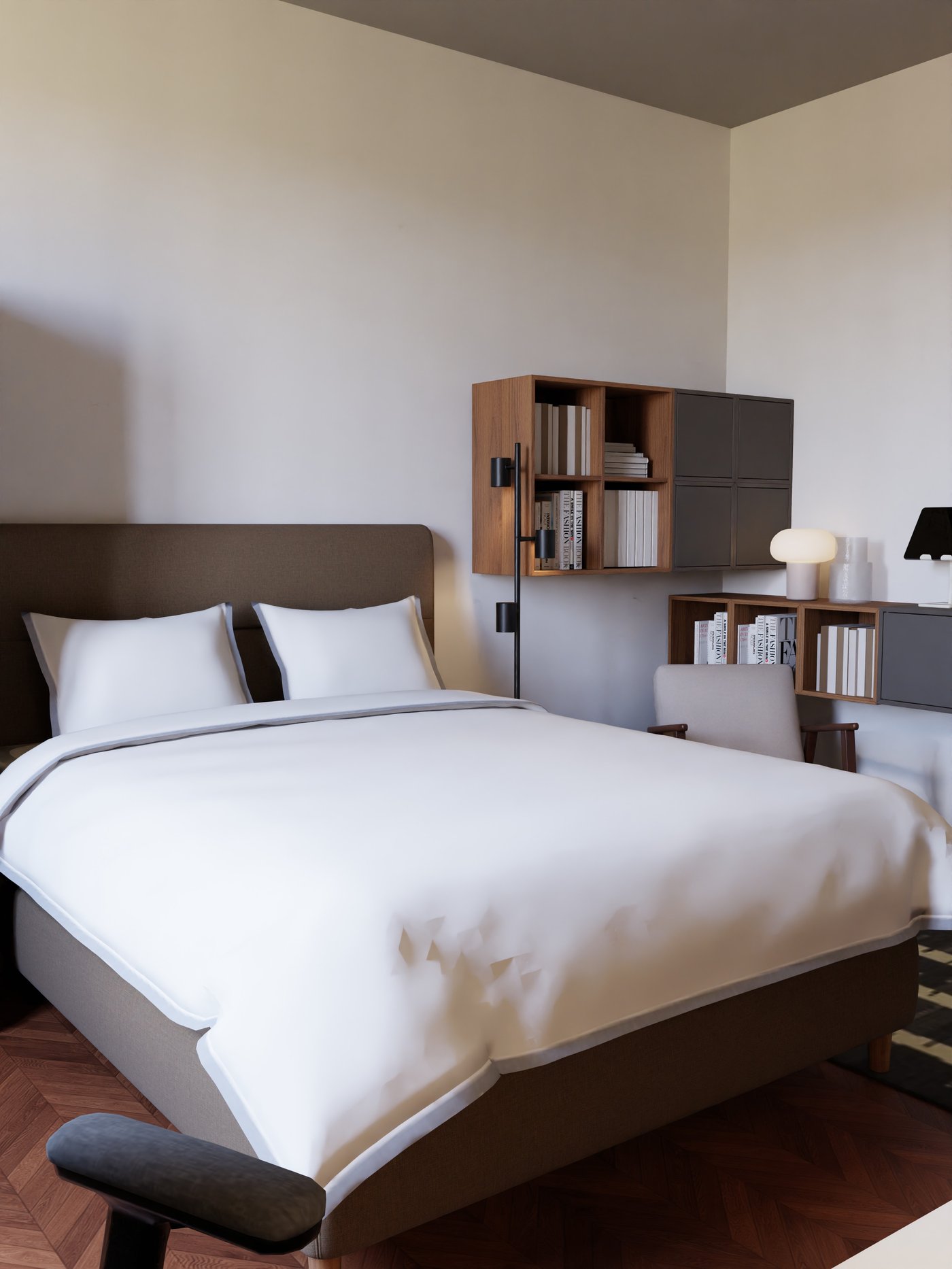 Boxspringbett mit weißer Bettwäsche und Leseecke mit Sessel