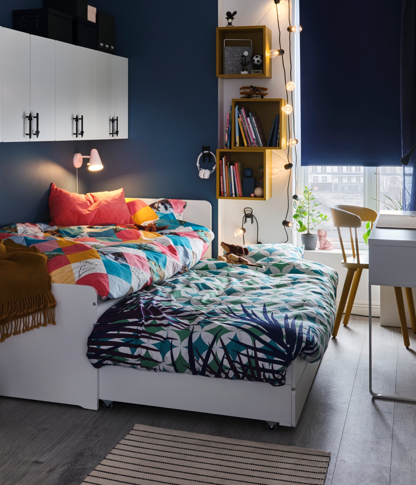 A white FUBBLA LED wall lamp in the bedroom