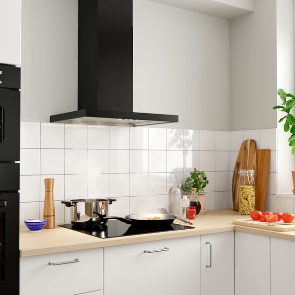 A black MATÄLSKARE wall mounted extractor hood in the kitchen