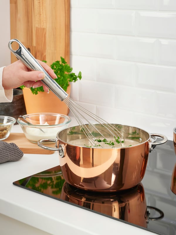 A stainless steel FINMAT balloon whisk