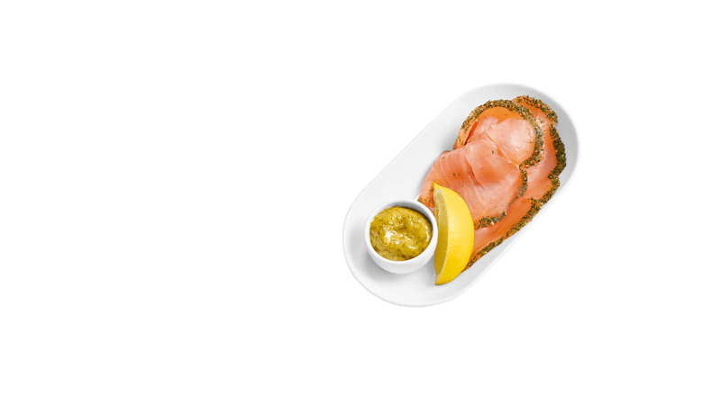 Ein weißchen Schälchen mit 2 Scheiben Lachs, einer viertel Zitrone und einem Schälchen Dill-Senf-Soße.
