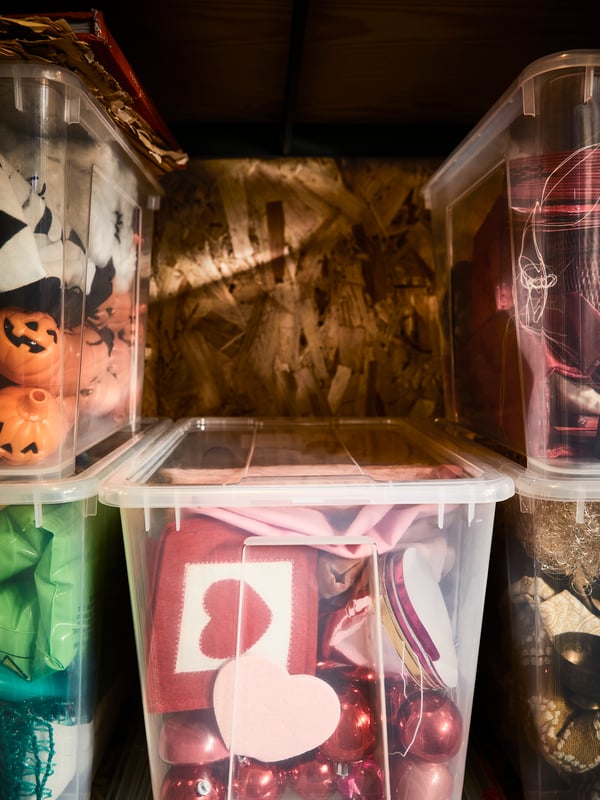 Close up on five SAMLA boxes filled with seasonal storage. The middle of the picture is empty, that box seems to be gone.