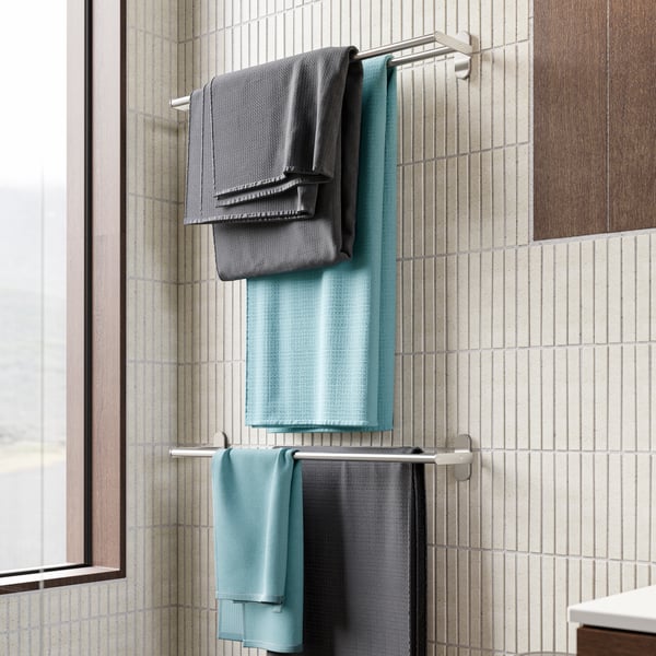 A close up of IKEA towl racks featuring gray and blue towels.