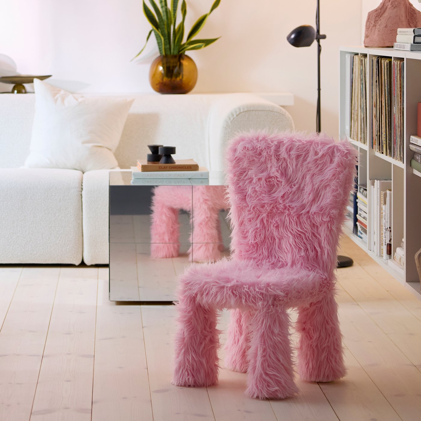 A faux fur/pink GREJSIMOJS cover for children's chair in the living room