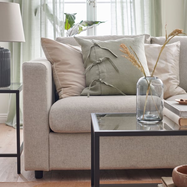 A light green AINA cushion cover in the living room