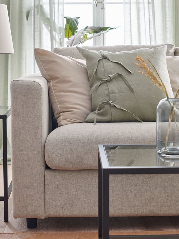 A light green AINA cushion cover in the living room