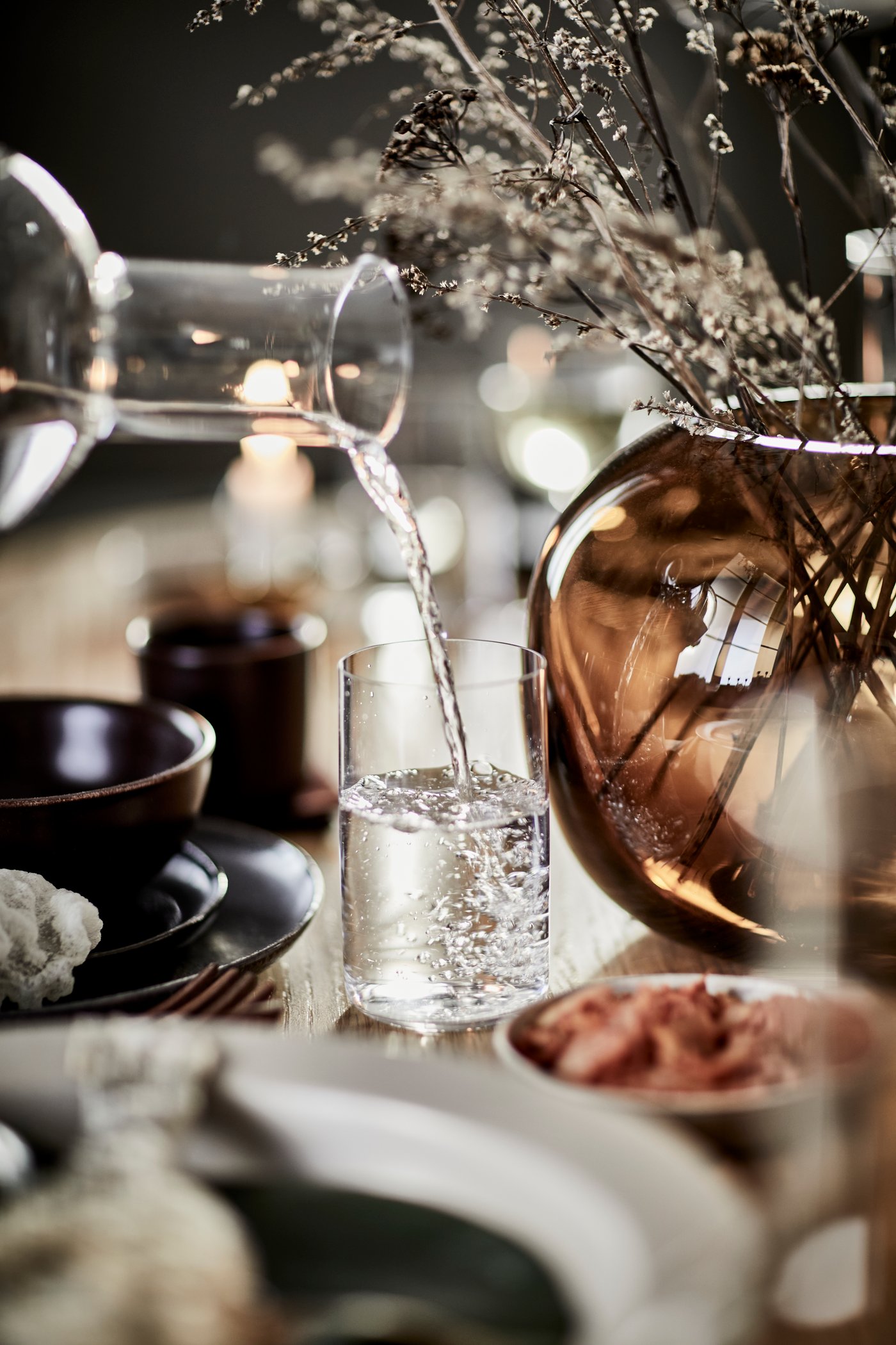 A black STOCKHOLM 2025 side plate in the dining room