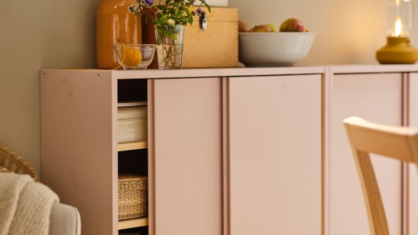 A pine IVAR cabinet with sliding doors in the bedroom