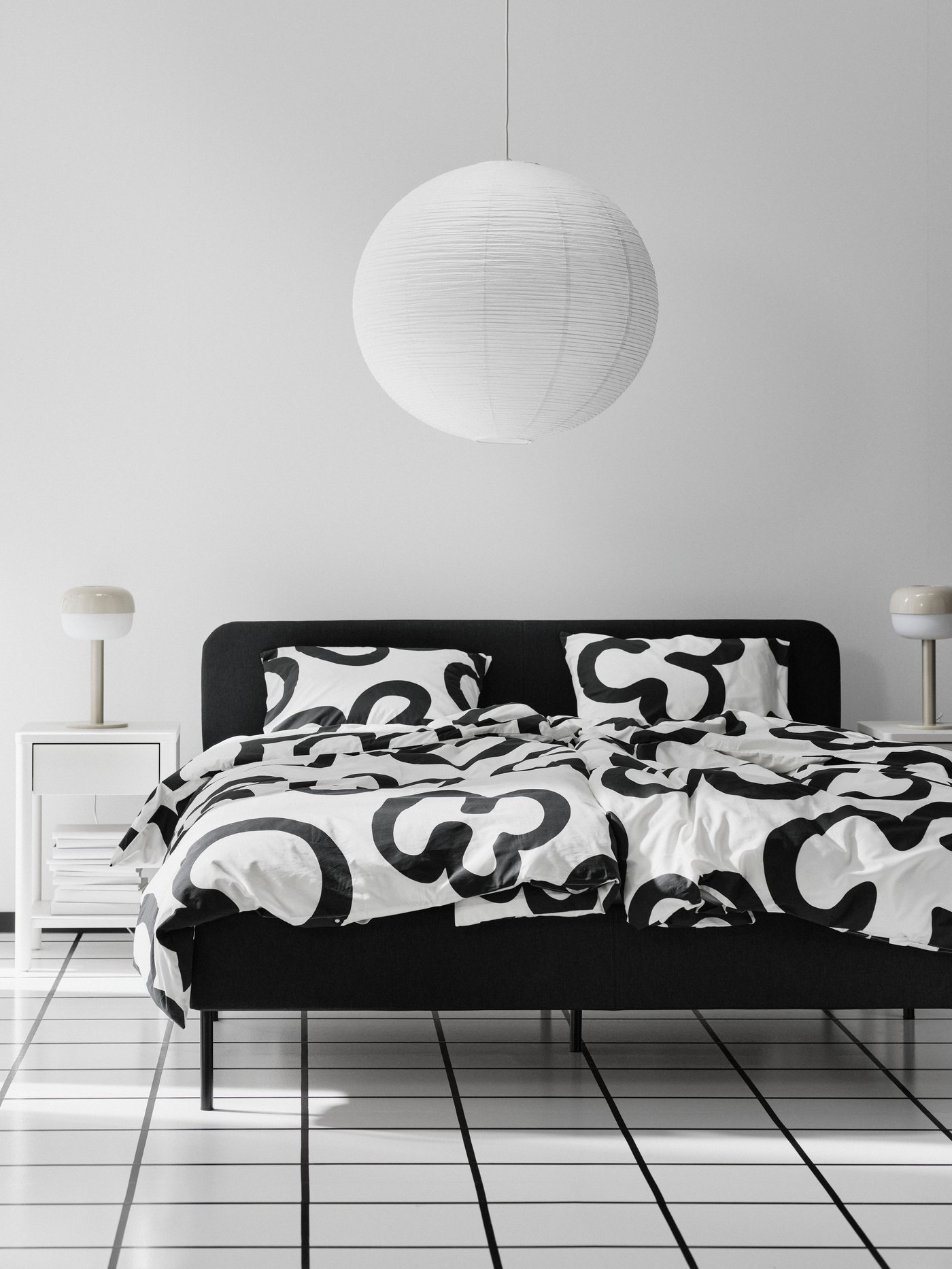 A Vissle dark grey SLATTUM upholstered bed frame in the bedroom