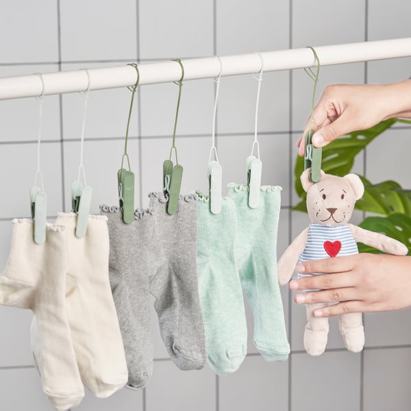 A green SLIBB hanging clothes peg