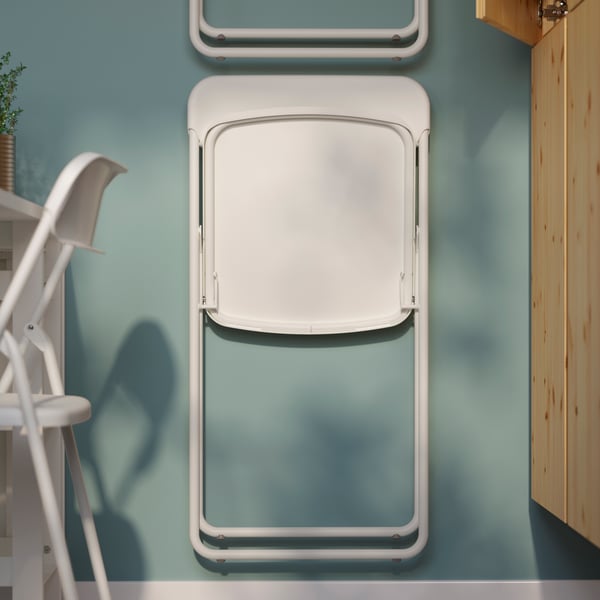 A white VIHALS folding chair