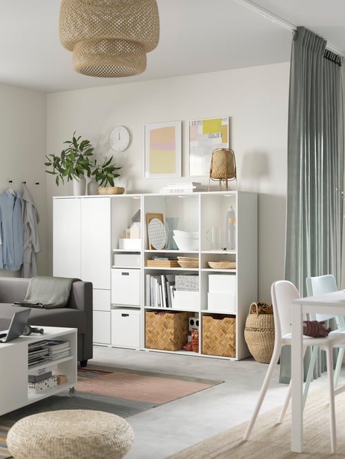 Living room with a storage combination with boxes and storage boxes with lid, a junior chair, and coffee table.