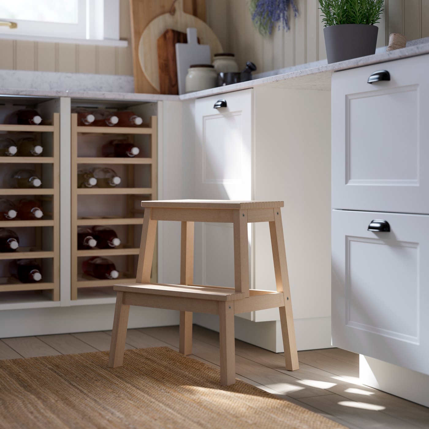 A wooden stool stands beside a kitchen counter with a light-coloured cupboard and a bottle-filled wine rack.