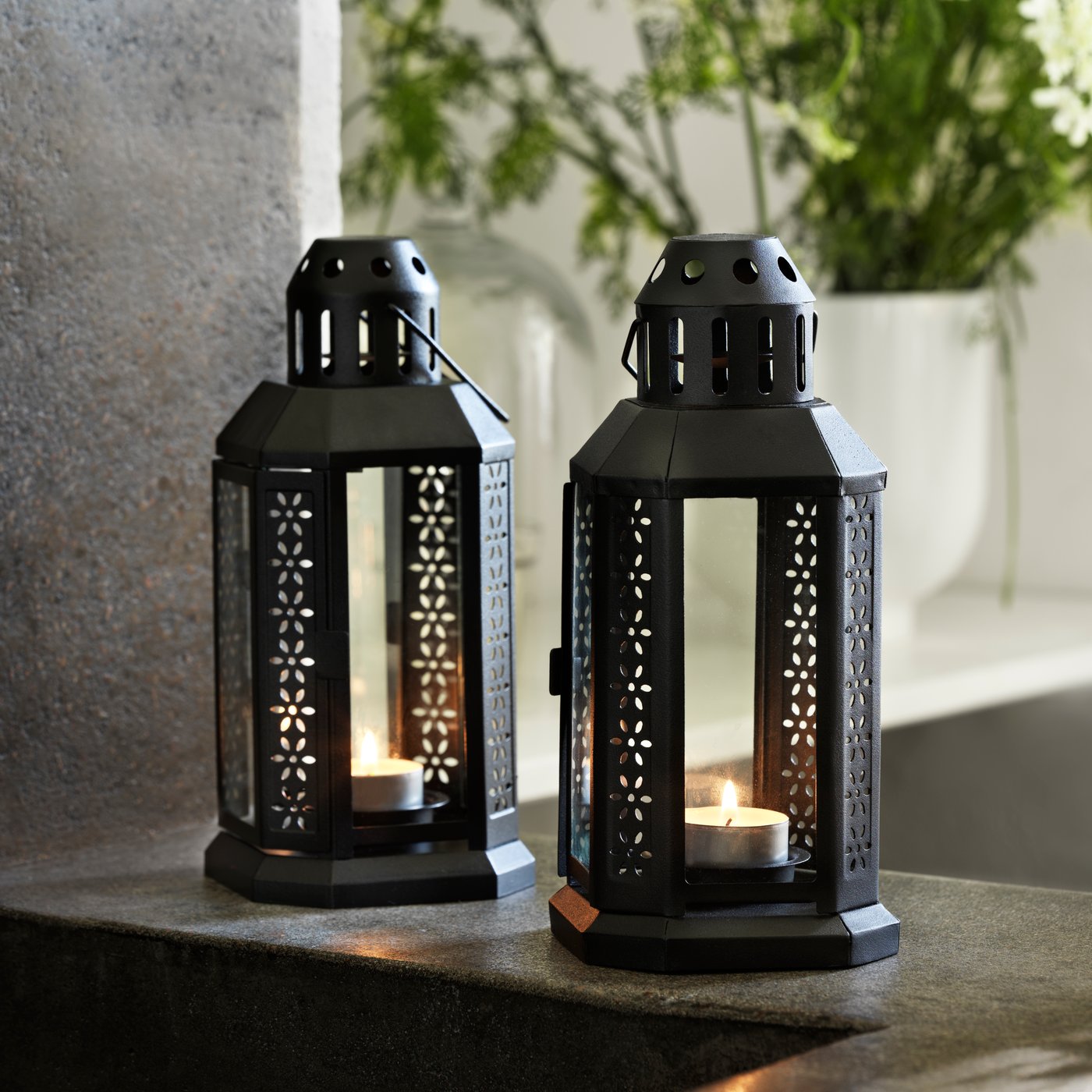 A black ENRUM lantern for tealight, in/outdoor