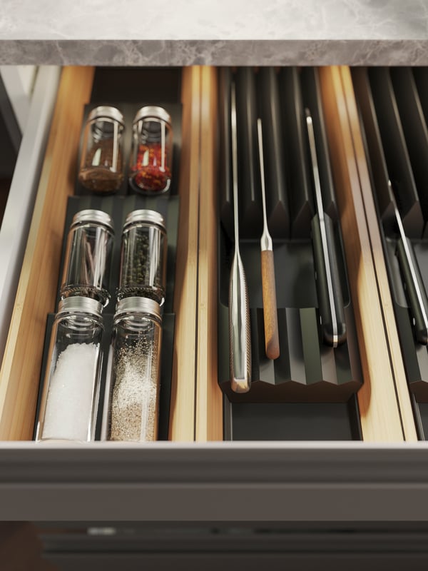 A clear glass/stainless steel GULDFISK spice jar