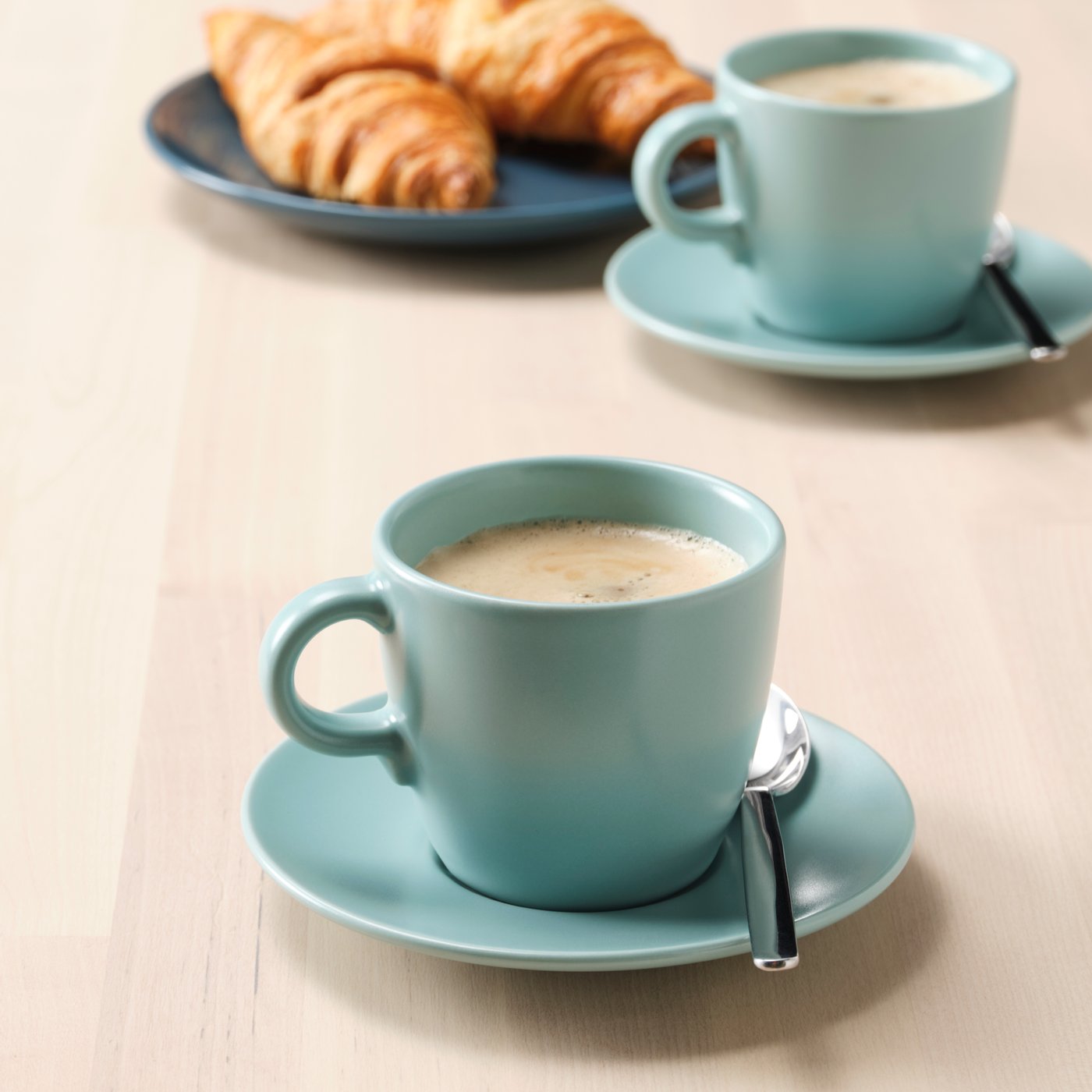 A matt light turquoise FÄRGKLAR cup with saucer