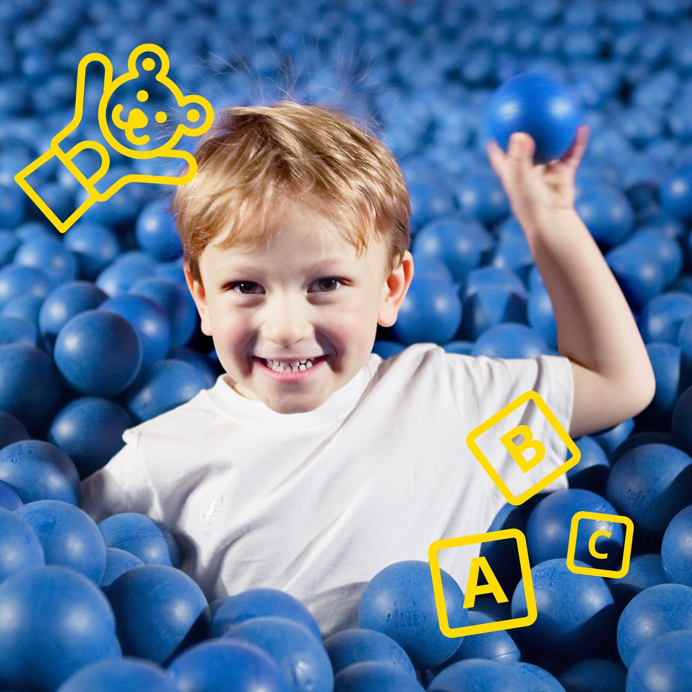 A boy is playing in a ball pool