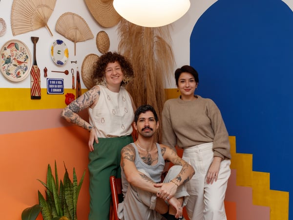 Felipe, Gabriela, and Giovanna posing in a corner of their shared creative space.