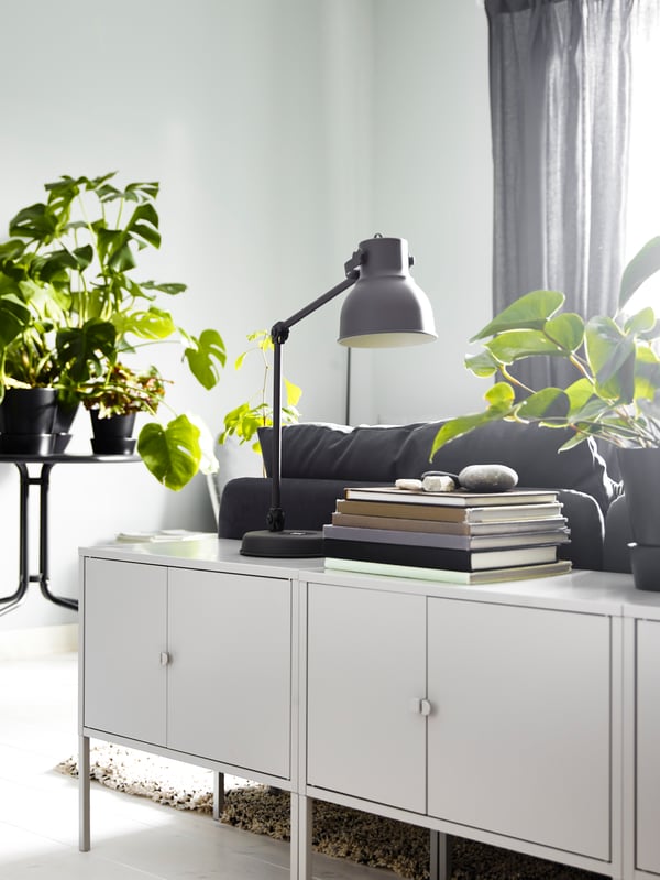 A couple of modern LIXHULT cabinets in metal/grey behind the sofa blending with the interior.