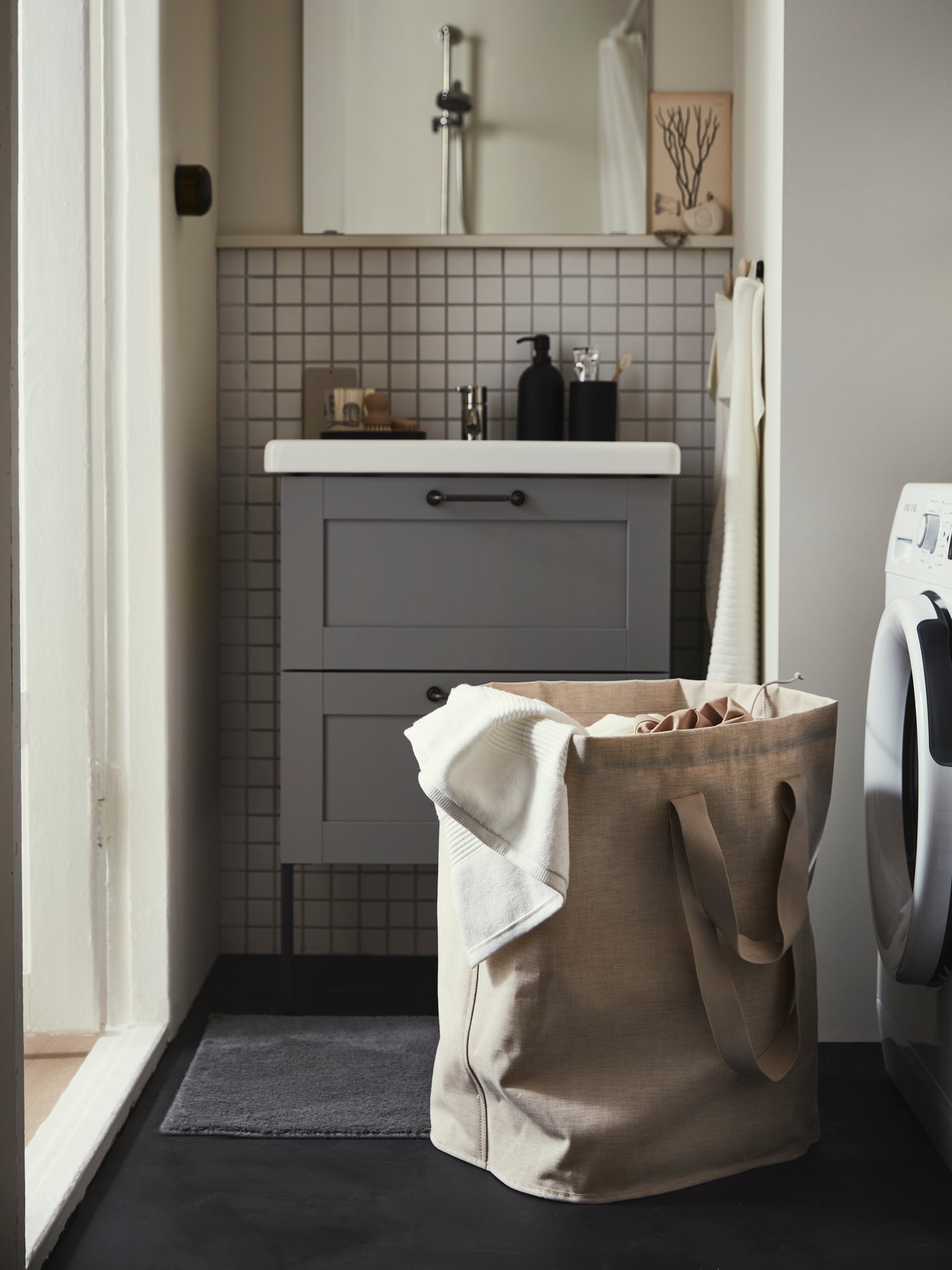 A grey/black HODDE rug flatwoven, in/outdoor in the bathroom