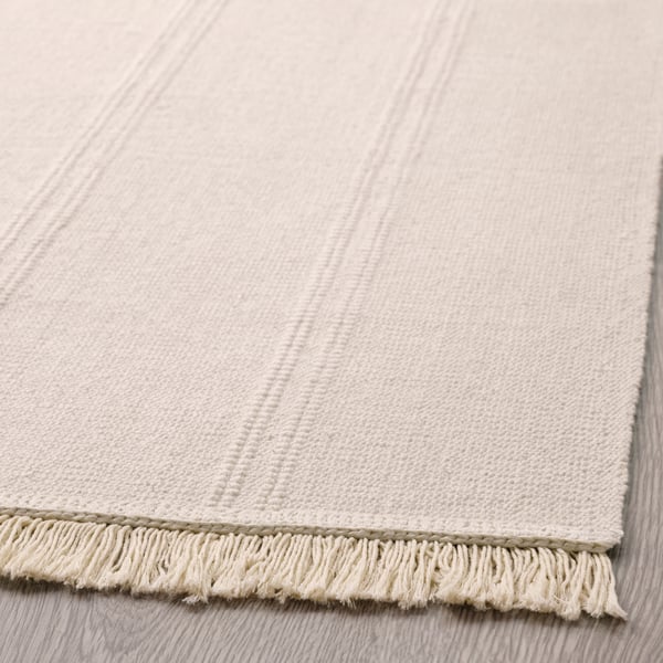 An unbleached SORTSÖ rug, flatwoven
