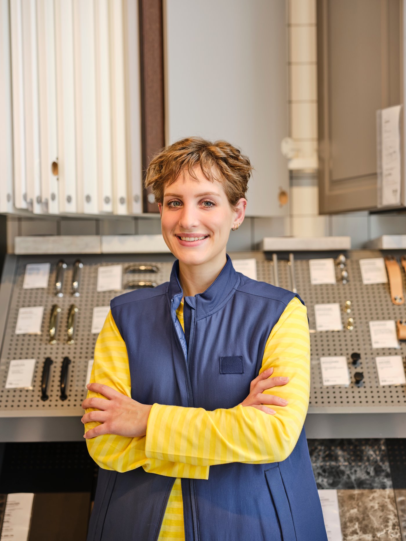 An IKEA co-worker wearing a uniform in a kitchen's department.