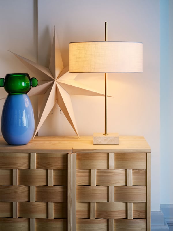 A white textile/brass-plated STOCKHOLM 2025 table lamp