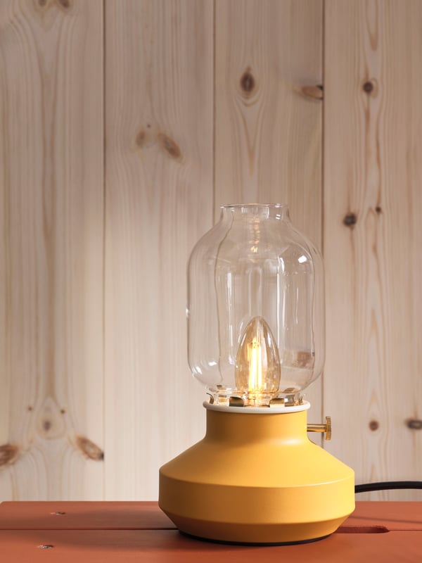 A dimmable dark yellow TÄRNABY table lamp